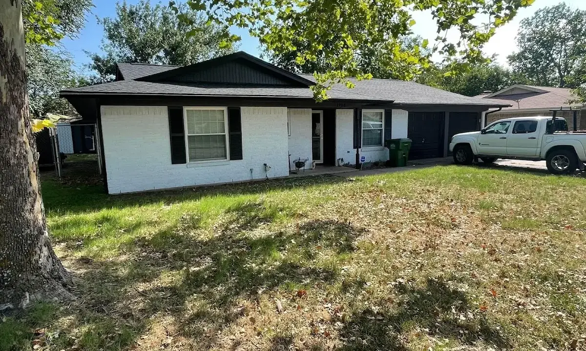 Professional roofing crew working on a residential roof in Floresville